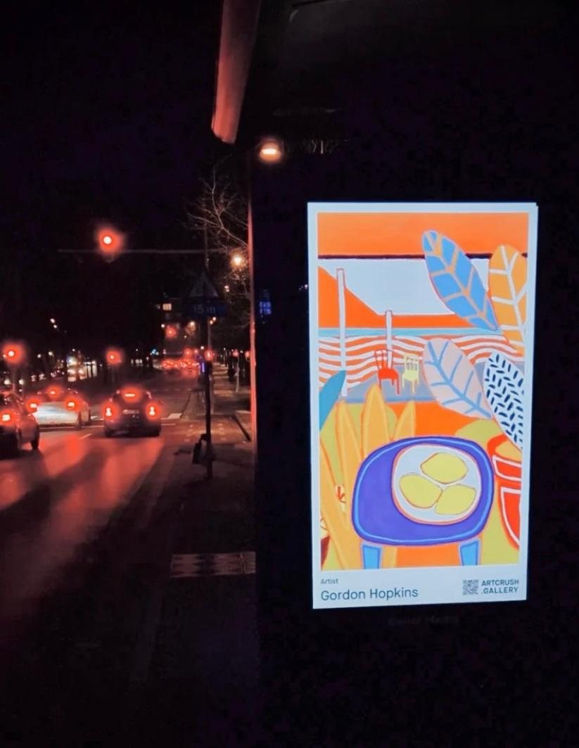 Gordon Hopkins on a roadside billboard at night